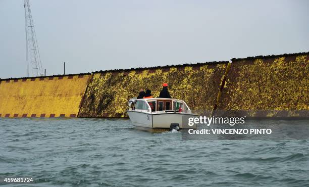 Technicians check the mobile gates of the Experimental Electromechanical Module , a project intended to protect Venice from floods, are totally...