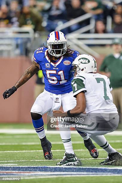 Brandon Spikes of the Buffalo Bills chases down ballcarrier Geno Smith of the New York Jets at Ford Field on November 24, 2014 in Detroit, Michigan.