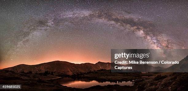 nighttime rainbow over the rockies - colorado rockies (mountains) stock pictures, royalty-free photos & images