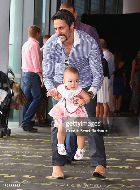 Mitchell Johnson of Australia plays with his daughter Rubika ahead of the Cricket Australia Christmas Day Lunch at Crown Metropol on December 25,...