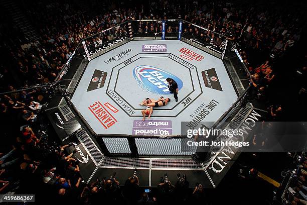 Ronda Rousey attempts to submit Miesha Tate in their UFC women's bantamweight championship bout during the UFC 168 event at the MGM Grand Garden...