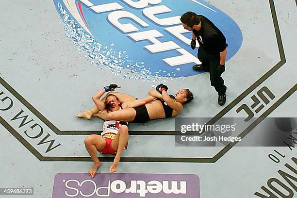 Ronda Rousey attempts to submit Miesha Tate in their UFC women's bantamweight championship bout during the UFC 168 event at the MGM Grand Garden...