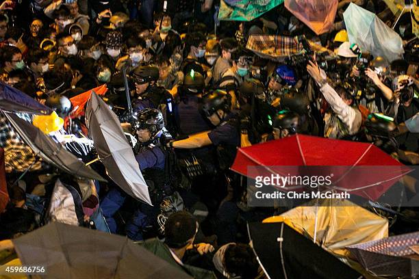 Pro-democracy activists clash with police on a street in Mong Kok on November 29, 2014 in Hong Kong. Clashes between police and pro-democracy...