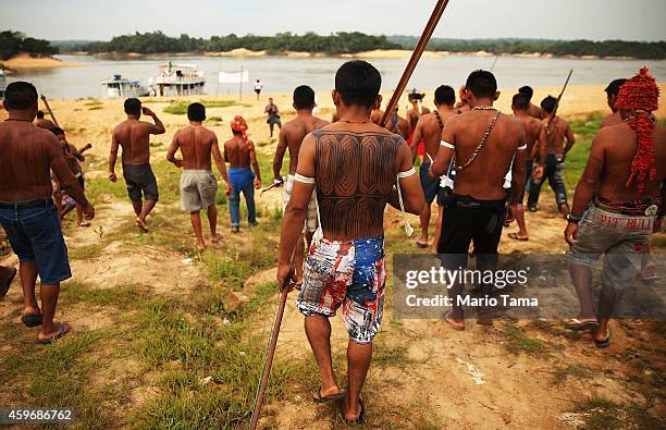 Members of the Munduruku indigenous tribe walk down to the Tapajos River during a "Caravan of Resistance'" protest by indigenous groups and...