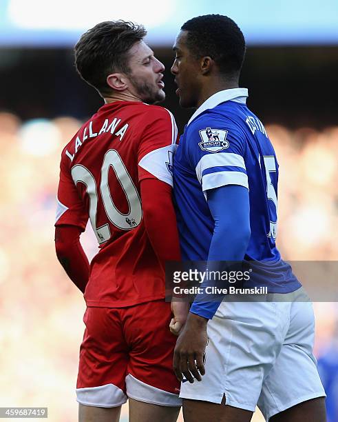 Adam Lallana of Southampton clashes with Sylvain Distin of Everton during the Barclays Premier League match between Everton and Southampton at...