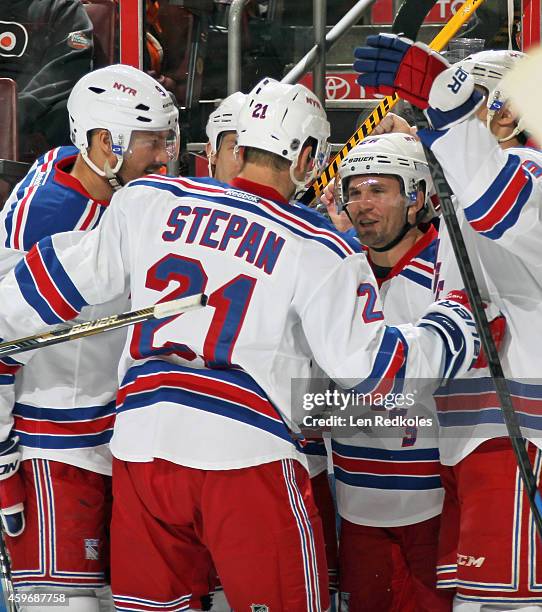 Martin St. Louis of the New York Rangers celebrates his second period power-play goal against the Philadelphia Flyers with teammates Kevin Klein,...
