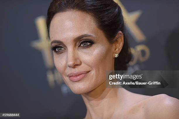 Actress/director Angelina Jolie poses in the press room during the 18th Annual Hollywood Film Awards at The Palladium on November 14, 2014 in...