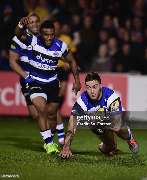 Bath player Matt Banahan dives over to score the first try as Kyle Eastmond celebrates during the Aviva Premiership match between Bath Rugby and...