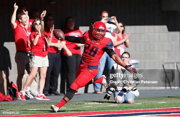 Safety Anthony Lopez of the Arizona Wildcats scores a 25 yard touchdown on a fumble recovery in the first quarter of the Territorial Cup college...