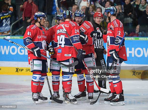 Julian Talbot, Jens Baxmann, Andre Rankel, Jimmy Sharrow and Barry Tallackson of the Eisbaeren Berlin celebrate after scoring the 3:2 during the game...