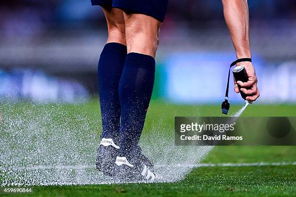 Referee Velasco Carballo uses vanishing spray during the La Liga match between Real Socided and Elche FC at Estadio Anoeta on November 28, 2014 in...