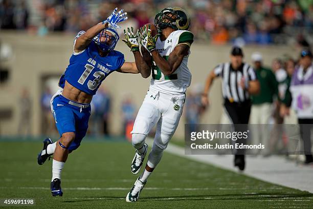 Wide receiver Rashard Higgins of the Colorado State Rams makes a catch for a first down while being defended by defensive back Justin DeCoud of the...