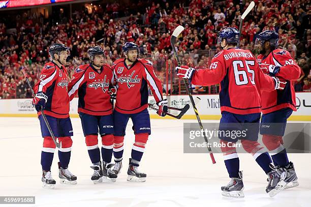 Matt Niskanen of the Washington Capitals celebrates his first period goal against the New York Islanders with teammates at Verizon Center on November...