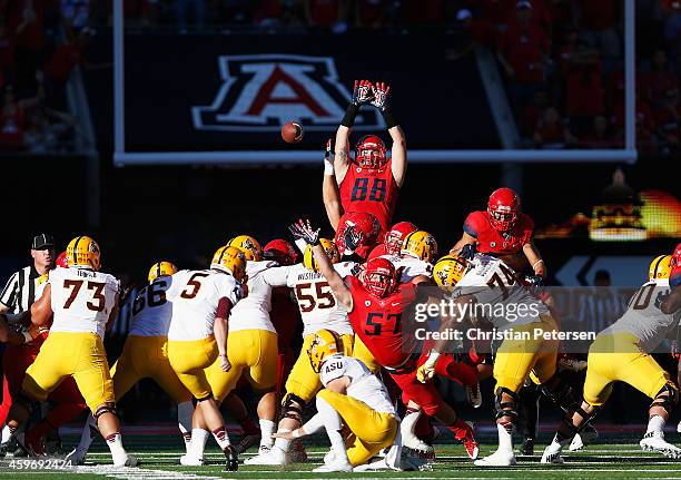 Tight end Trevor Wood of the Arizona Wildcats leaps as he attempts to block an unsuccessful field goal kicked by place kicker Zane Gonzalez of the...