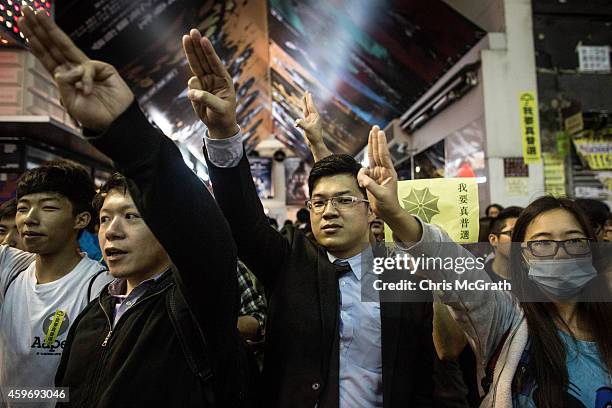 Pro-democracy protesters raise a three finger salute taken from the movie series "The Hunger Games" on November 28, 2014 in Hong Kong. Clashes...