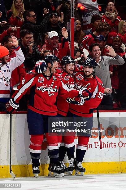 Evgeny Kuznetsov of the Washington Capitals celebrates with Marcus Johansson and Brooks Orpik after scoring a goal in the third period against the...
