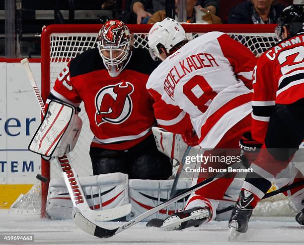 Justin Abdelkader of the Detroit Red Wings scores a powerplay goal at 12:52 of the second period against Cory Schneider of the New Jersey Devils at...