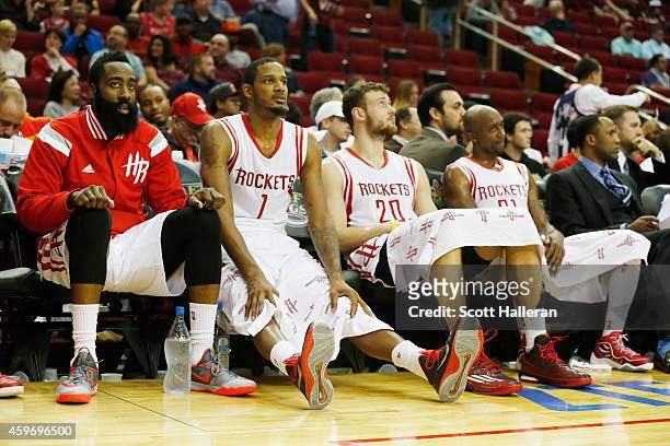 James Harden, Trevor Ariza, Donatas Motiejunas and Jason Terry of the Houston Rockets sit on the bench late in their game against the Los Angeles...