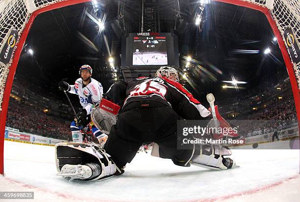 Youri Ziffzer , goaltender of Koeln saves the puck during the DEL match between Koelner Haie and Schwenninger Wild Wings at Lanxess Arena on December...