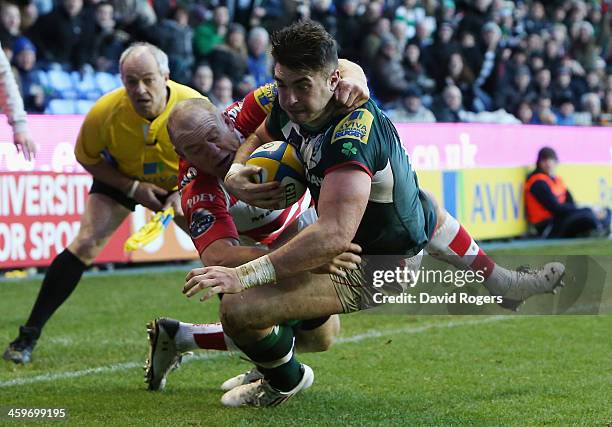 Eamonn Sheridan of London Irish dives over for a second half try despite being held by Mike Tindall during the Aviva Premiership match between London...