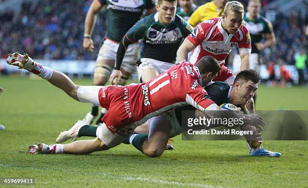Eamonn Sheridan of London Irish dives over for his second try despite being held by Jonny May during the Aviva Premiership match between London Irish...