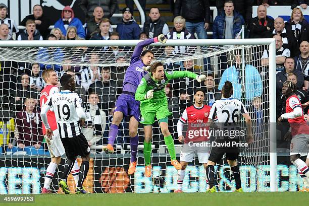Wojciech Szczesny of Arsenal clears the ball under pressure from Tim Krul of Newcastle during the Barclays Premier League match between Newcastle...