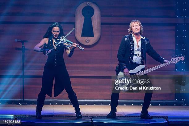 Violinist Asha Mevlana and bassist John Lee Middleton of Trans-Siberian Orchestra perform on stage at Viejas Arena on November 28, 2014 in San Diego,...