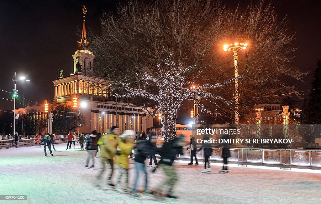 People skate along a skating ring at the Russia's Exhibition Center ...