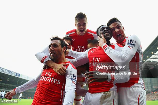 Danny Welbeck of Arsenal celebrates with team mate Olivier Giroud , Santi Cazorla and Calum Chambers as he scores their first goal during the...