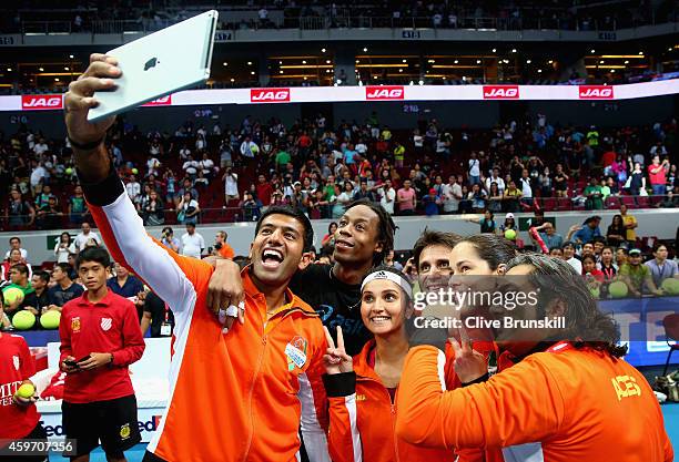 Rohan Bopanna of the Indian Aces takes a team selfie after their victory against the Manila Mavericks during the Coca-Cola International Premier...