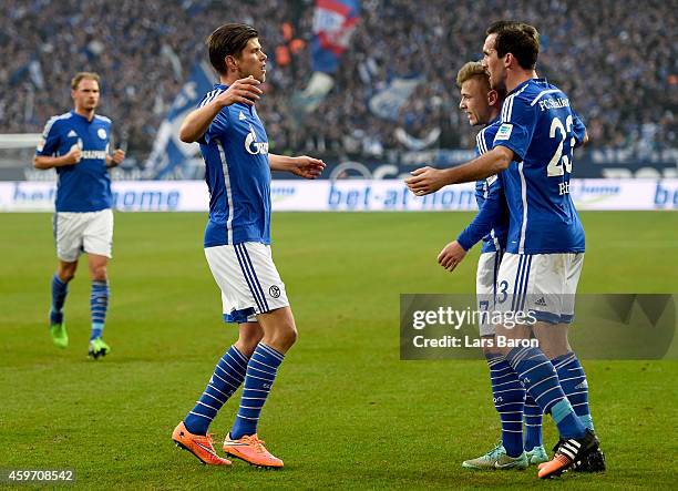 Klaas Jan Huntelaar of FC Schalke 04 celebrates with team mates Max Meyer of FC Schalke 04 and Christian Fuchs of FC Schalke 04 afer scoring his...