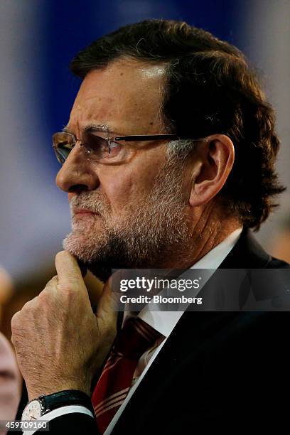 Mariano Rajoy, Spain's prime minister, listens as Alicia Sanchez-Camacho, leader of the Popular Party in Catalonia, speaks during a news conference...