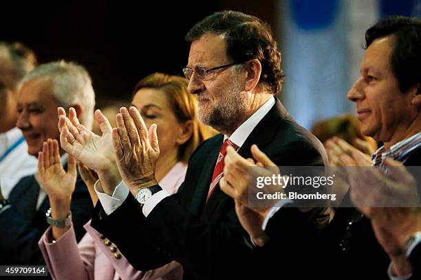 Mariano Rajoy, Spain's prime minister, center, applauds following a speech by Alicia Sanchez-Camacho, leader of the Popular Party in Catalonia, in...