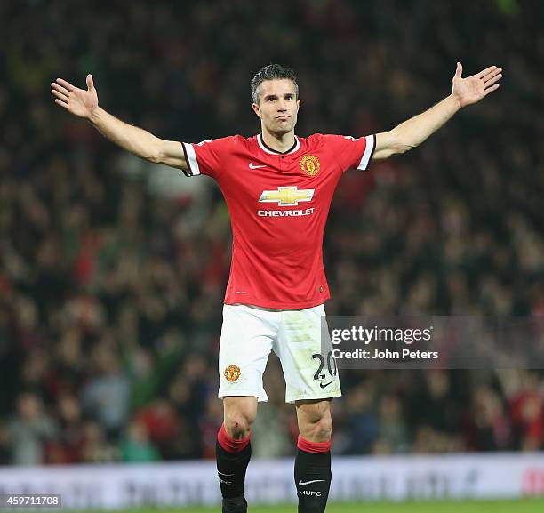 Robin van Persie of Manchester United celebrates scoring their third goal during the Barclays Premier League match between Manchester United and Hull...