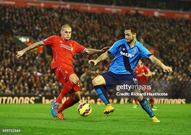 Martin Skrtel of Liverpool tackles Marko Arnautovic of Stoke City during the Barclays Premier League match between Liverpool and Stoke City at...