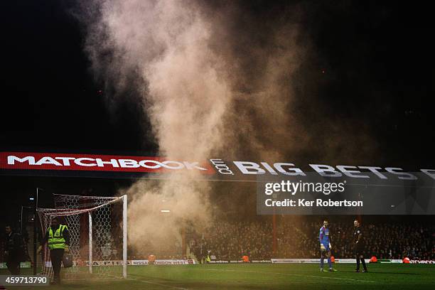 Play is halted after a distress flare is thrown onto the pitch during the Sky Bet Championship match between Brentford and Wolverhampton Wanderers at...