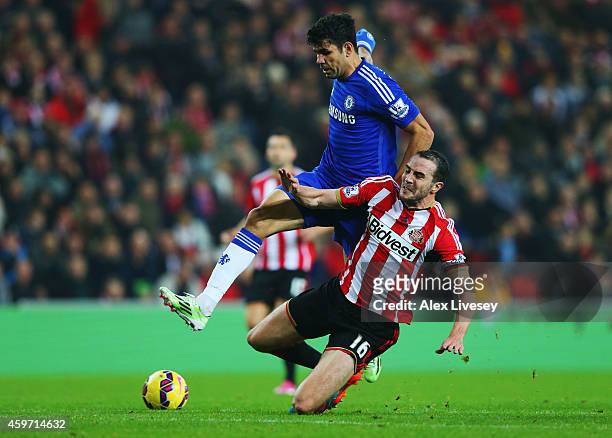 John O'Shea of Sunderland challenges Diego Costa of Chelsea during the Barclays Premier League match between Sunderland and Chelsea at Stadium of...