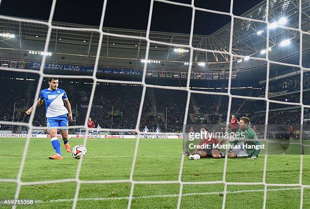 Kevin Volland of Hoffenheim scores his team's second goal past goalkeeper Ron-Robert Zieler of Hannover and Miiko Albornoz of Hannover during the...