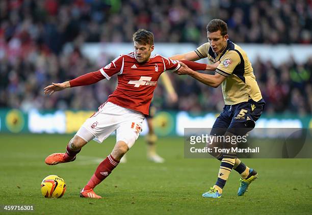 Jamie Mackie of Nottingham Forest tackled by Jason Pearce of Leeds United during the Sky Bet Championship match between Nottingham Forest and Leeds...