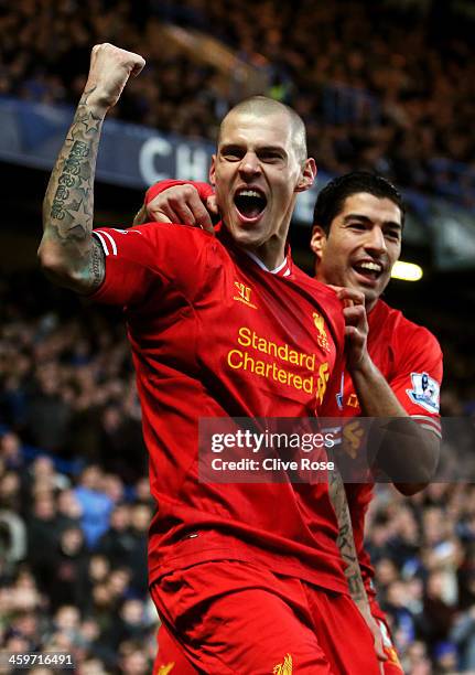 Martin Skrtel of Liverpool celebrates with teammate Luis Suarez after scoring the opening goal during the Barclays Premier League match between...