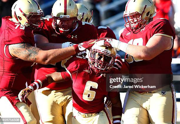 Sherman Alston of the Boston College Eagles celebrates with his teammates following his touchdown catch in the second quarter against the Syracuse...