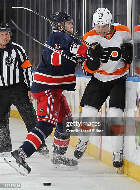 Dan Girardi of the New York Rangers throws a hit against Brayden Schenn of the Philadelphia Flyers at Madison Square Garden on November 29, 2014 in...