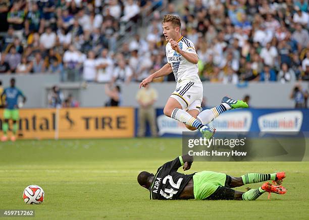 Robbie Rogers of Los Angeles Galaxy is tripped by Micheal Azira of Seattle Sounders FC during the Western Conference Final at StubHub Center on...