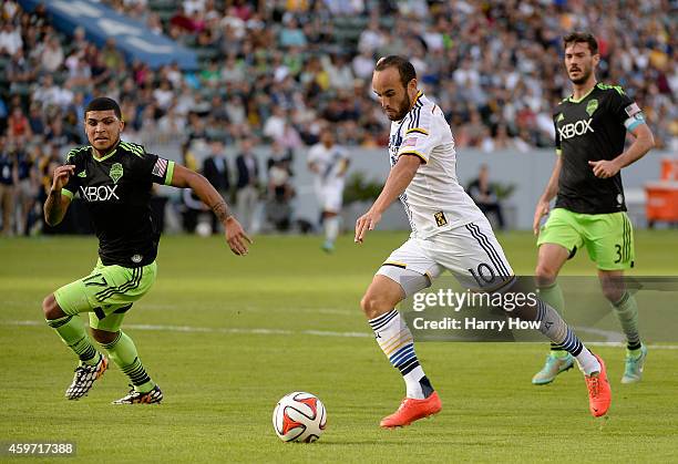 Landon Donovan of Los Angeles Galaxy attempts a shot in front of Deindre Yedlin and Brad Evans of Seattle Sounders FC during the Western Conference...