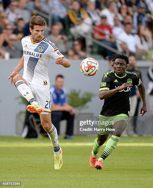 Tommy Meyer of Los Angeles Galaxy controls a bouncing ball in front of Obafemi Martins of Seattle Sounders FC during the Western Conference Final at...