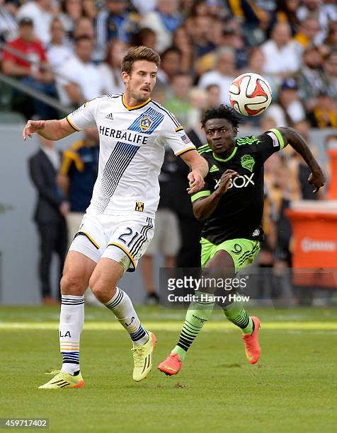 Tommy Meyer of Los Angeles Galaxy controls a bouncing ball in front of Obafemi Martins of Seattle Sounders FC during the Western Conference Final at...