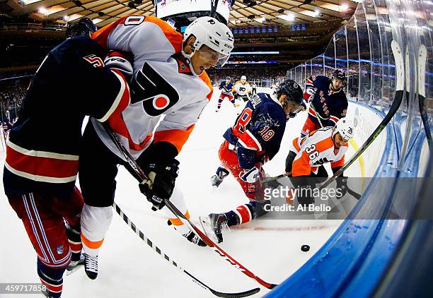 Dan Girardi, Marc Staal, and Mats Zuccarello of the New York Rangers battle Vincent Lecavalier, and Zac Rinaldo of the Philadelphia Flyers during...