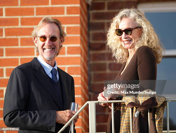 Mike Rutherford and Angie Rutherford watch the racing as they attend the Hennessy Gold Cup race meeting at Newbury Racecourse on November 29, 2014 in...
