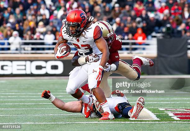 Prince-Tyson Gulley of the Syracuse Orangemen is tackled after running with the ball by Josh Keyes in the second half during the game at Alumni...