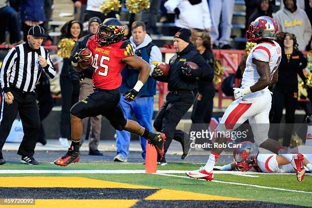 Running back Brandon Ross of the Maryland Terrapins rushes for a first half touchdown against the Rutgers Scarlet Knights at Byrd Stadium on November...